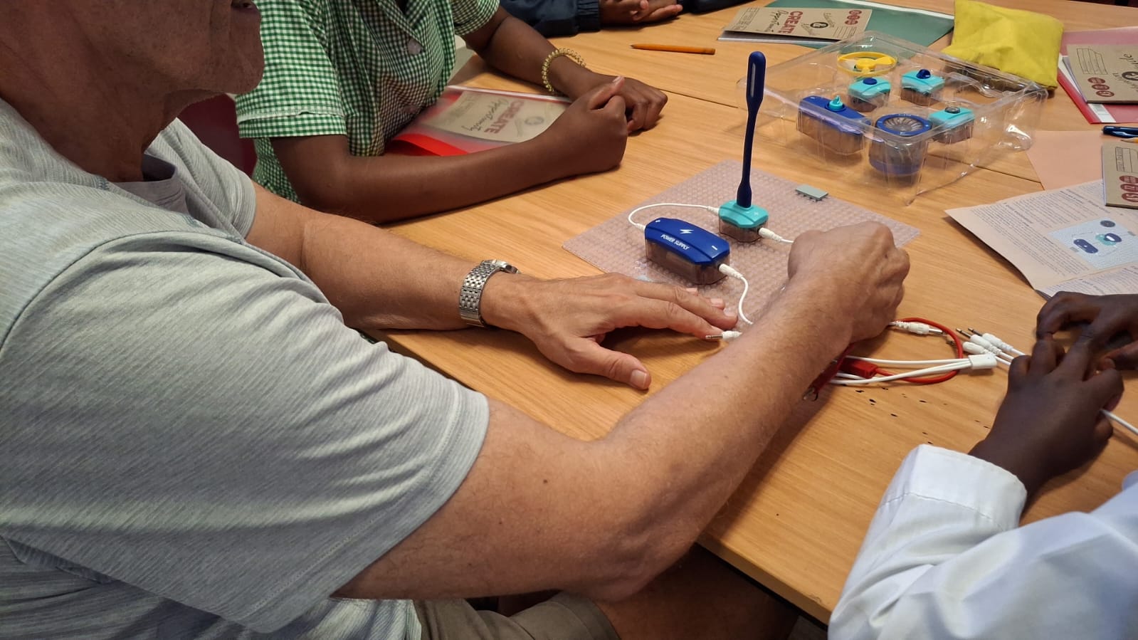 Learners working on electronics during a session